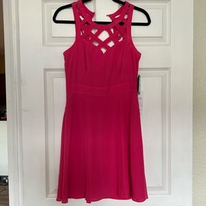 Pink sleeveless dress with cross design. Brand new.